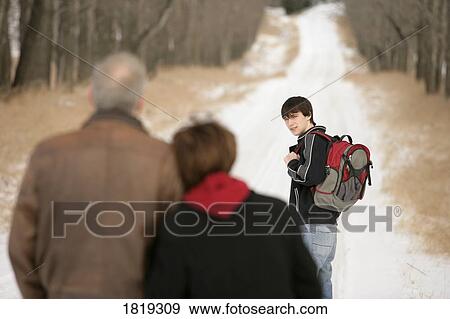 A teenage boy walking on a snow-covered path View Large Photo Image Stock Photo - A teenage boy walking on a snow-covered path. Fotosearch
