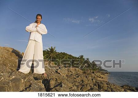 Stock Image - A woman meditating. Fotosearch