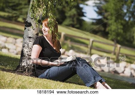 A woman reading in the park View Large Photo Image Picture - A woman reading in the park. Fotosearch