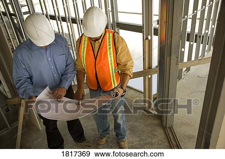 Architect consulting construction worker View Large Photo Image Stock Photo - Architect consulting construction worker. Fotosearch
