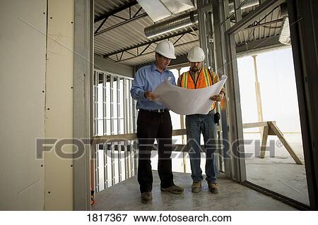 Architect consulting with construction worker View Large Photo Image Stock Photo - Architect consulting with construction worker. Fotosearch