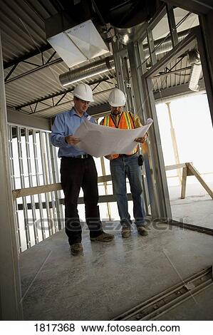 Architect consulting with construction worker View Large Photo Image Stock Photo - Architect consulting with construction worker. Fotosearch