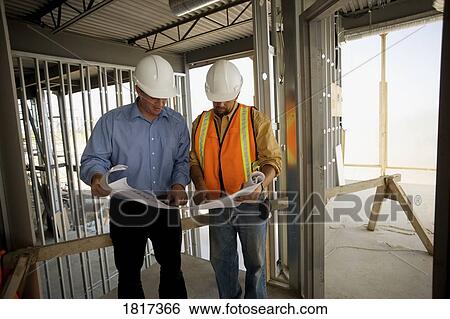 Architect consulting with construction worker View Large Photo Image Stock Photograph - Architect consulting with construction worker. Fotosearch