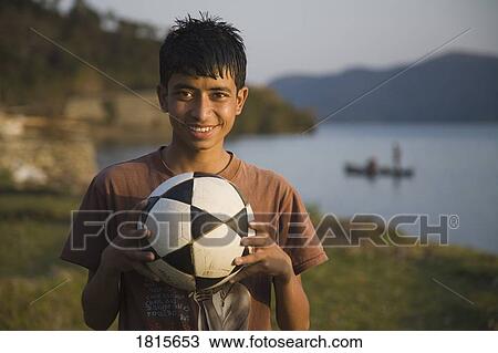 Boy holding a soccer ball View Large Photo Image Stock Image - Boy holding a soccer ball. Fotosearch
