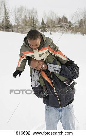 Boy on father's shoulders View Large Photo Image Stock Image - Boy on father's shoulders. Fotosearch