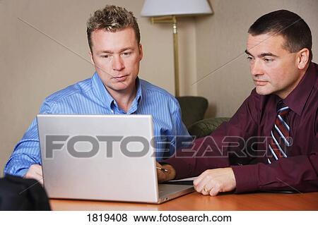 Businessmen on a computer View Large Photo Image Stock Photo - Businessmen on a computer. Fotosearch