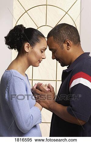 Stock Photography - Couple praying together. Fotosearch