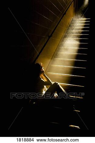 Depressed girl in stairwell with light streaming in View Large Photo Image Picture - Depressed girl in stairwell with light streaming in. Fotosearch