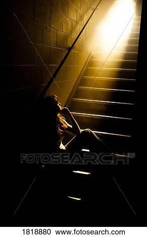 Depressed girl in stairwell with light streaming in View Large Photo Image Stock Image - Depressed girl in stairwell with light streaming in. Fotosearch