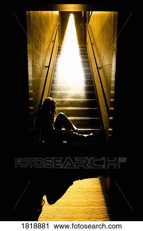 Depressed girl in stairwell with light streaming in View Large Photo Image Stock Image - Depressed girl in stairwell with light streaming in. Fotosearch