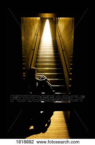 Depressed girl in stairwell with light streaming in View Large Photo Image Stock Image - Depressed girl in stairwell with light streaming in. Fotosearch