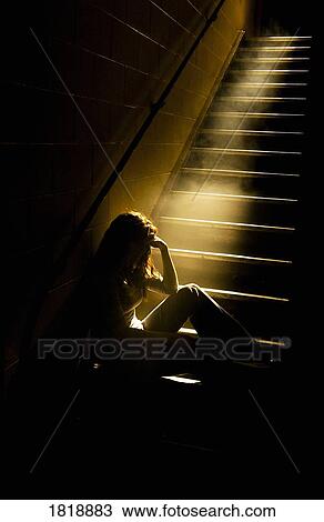 Depressed girl in stairwell with light streaming in View Large Photo Image Stock Image - Depressed girl in stairwell with light streaming in. Fotosearch