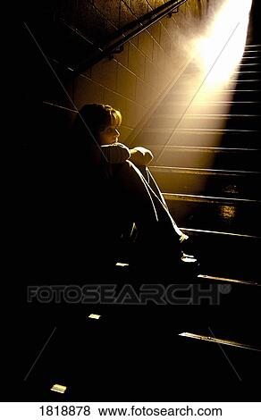 Depressed girl in stairwell with light streaming in View Large Photo Image Stock Photo - Depressed girl in stairwell with light streaming in. Fotosearch
