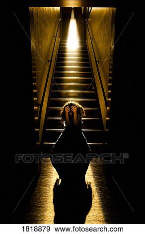 Depressed girl in stairwell with light streaming in View Large Photo Image Stock Photo - Depressed girl in stairwell with light streaming in. Fotosearch