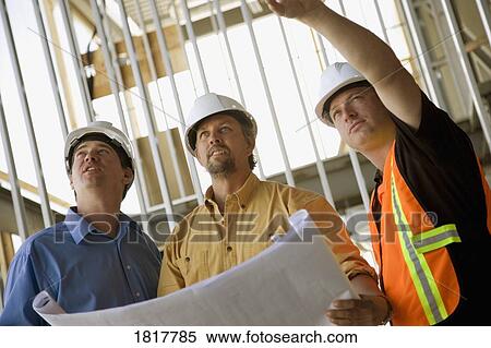Discussing the architecture of new construction View Large Photo Image Stock Photography - Discussing the architecture of new construction. Fotosearch