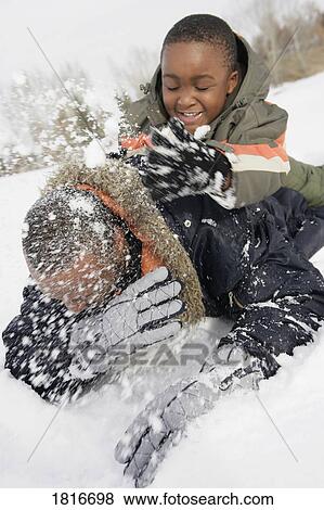 Stock Photo - Father and son playing in snow. Fotosearch