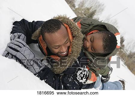 Father and son playing on snow View Large Photo Image Stock Photography - Father and son playing on snow. Fotosearch