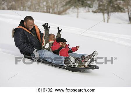 Father and sons sledding on snow View Large Photo Image Stock Image - Father and sons sledding on snow. Fotosearch