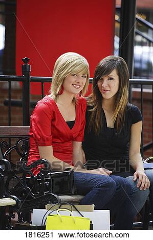 Friends sitting after shopping View Large Photo Image Stock Image - Friends sitting after shopping. Fotosearch