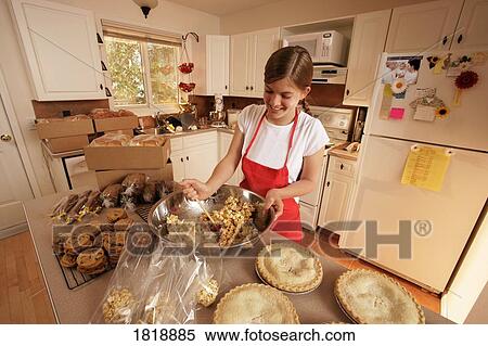 Stock Photography - Girl baking in the kitchen. Fotosearch