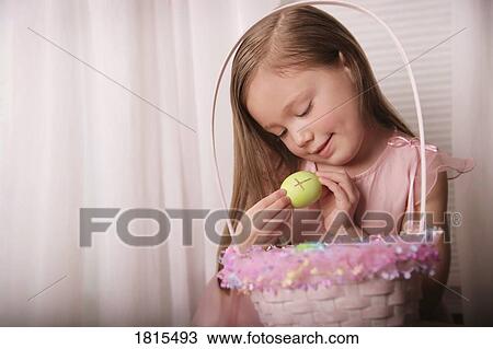 Girl holding Easter egg with cross drawn on it View Large Photo Image Stock Image - Girl holding Easter egg with cross drawn on it. Fotosearch