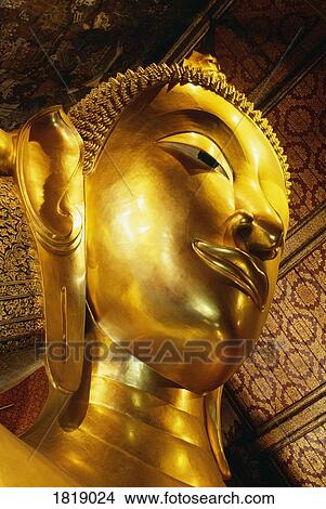 Picture - Head of Reclining Buddha at Wat Po, Bangkok, Thailand. Fotosearch