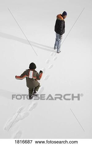 High angle view of people walking on snow View Large Photo Image Stock Photo - High angle view of people walking on snow. Fotosearch