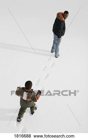 High angle view of people walking on snow View Large Photo Image Stock Photo - High angle view of people walking on snow. Fotosearch