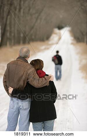 Husband and wife watching their son leave View Large Photo Image Stock Image - Husband and wife watching their son leave. Fotosearch