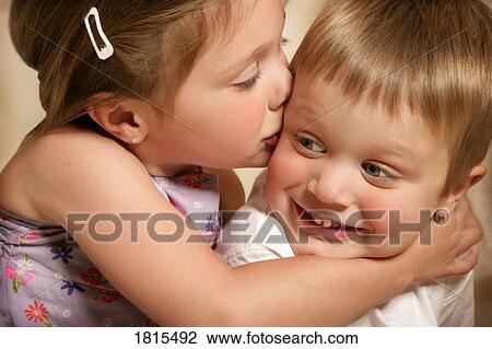 Stock Image - Little girl kisses boy's cheek . Fotosearch