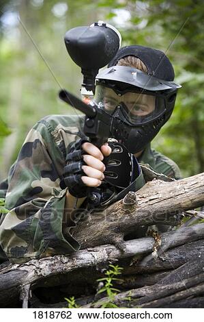 Stock Image - Male aiming a paintball gun. Fotosearch
