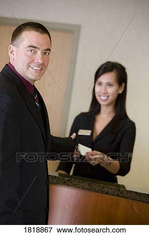 Man and woman at front desk View Large Photo Image Stock Photo - Man and woman at front desk. Fotosearch