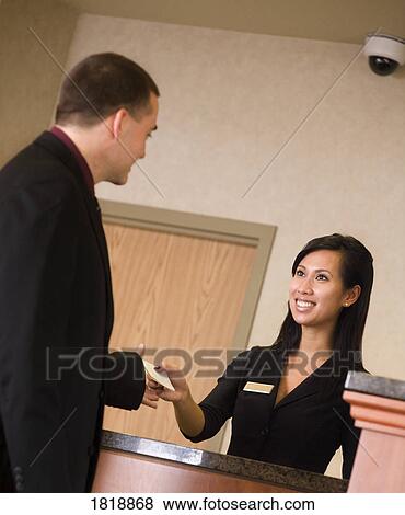 Man and woman at front desk View Large Photo Image Stock Photo - Man and woman at front desk. Fotosearch