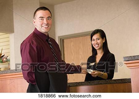 Man and woman at front desk View Large Photo Image Stock Photograph - Man and woman at front desk. Fotosearch