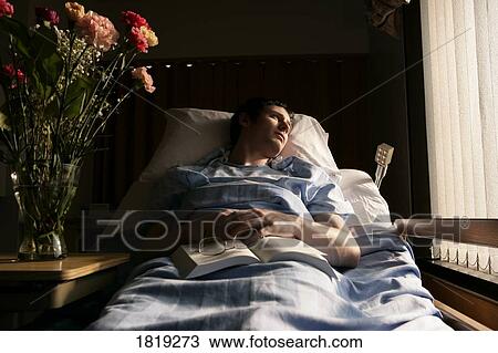 Stock Image - Man in a hospital bed. Fotosearch