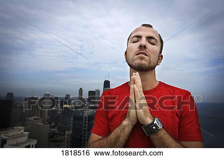 Stock Photograph - Man praying. Fotosearch