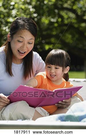 Mother reading to daughter View Large Photo Image Stock Image - Mother reading to daughter. Fotosearch