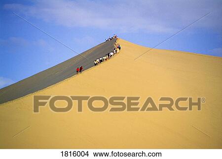 People climbing sand dune View Large Photo Image Picture - People climbing sand dune. Fotosearch