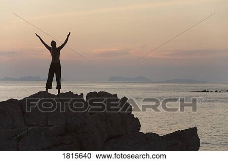 Stock Image - Person with arms raised. Fotosearch