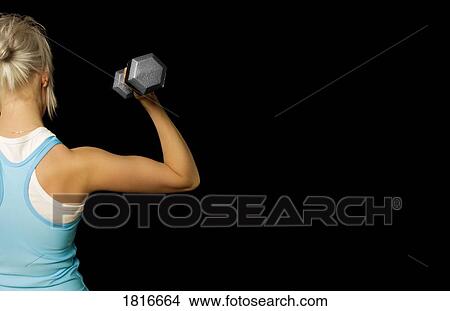 Picture - Rear view of woman holding dumbbell. Fotosearch