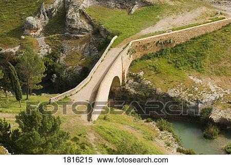 Stock Photography - Restored Medieval Stone Bridge leading to the Castle at Alarcón, Cuenca, Castilla, La Mancha, Spain . Fotosearch