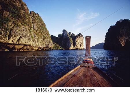 Rock formations by sea and boat bow View Large Photo Image Stock Image - Rock formations by sea and boat bow . Fotosearch