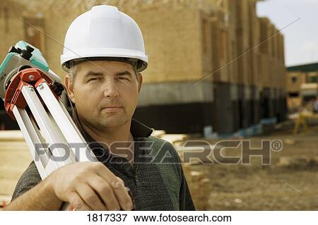 Surveyor at construction site View Large Photo Image Stock Photo - Surveyor at construction site. Fotosearch