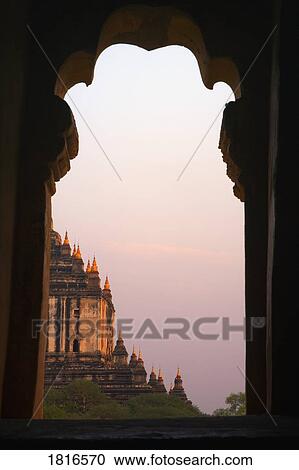 Temple at sunset seen from Temple window in Myanmar, Burma View Large Photo Image Stock Image - Temple at sunset seen from Temple window in Myanmar, Burma. Fotosearch
