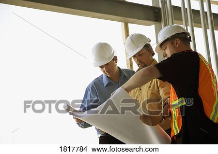 Picture - Three men with blueprint. Fotosearch
