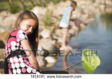 Two girls on the shore View Large Photo Image Stock Image - Two girls on the shore. Fotosearch