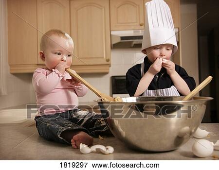 Two kids making cookie dough View Large Photo Image Stock Photo - Two kids making cookie dough. Fotosearch