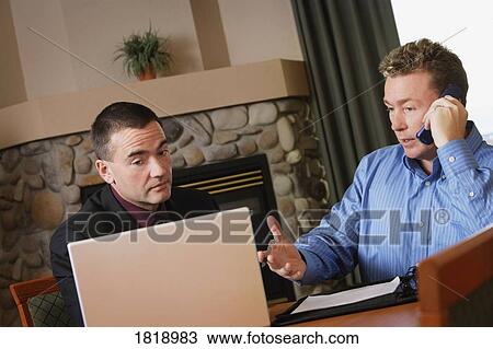 Stock Image - Two men having a discussion. Fotosearch