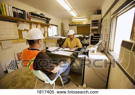 Stock Photography - Two men in a construction office. Fotosearch