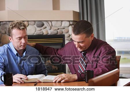 Stock Photo - Two men praying. Fotosearch